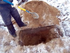 digging out a piece of unexploded ordnance