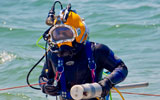 UXO diver with magnetometer in patented HeckHousing™