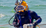 UXO diver with magnetometer in patented HeckHousing™