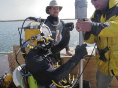 dive team preparing to locate underwater UXO with magnetometer
