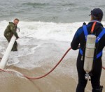 fighting the surf to recover underwater UXO