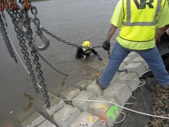 diver assists with placement of concrete mats